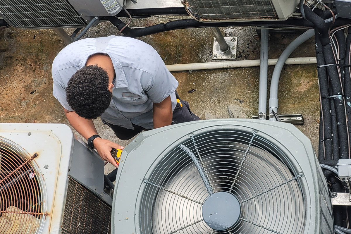 An HVAC technician installing a new HVAC system